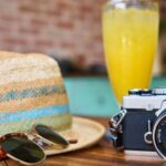 Vacation - Gray and Black Dslr Camera Beside Sun Hat and Sunglasses