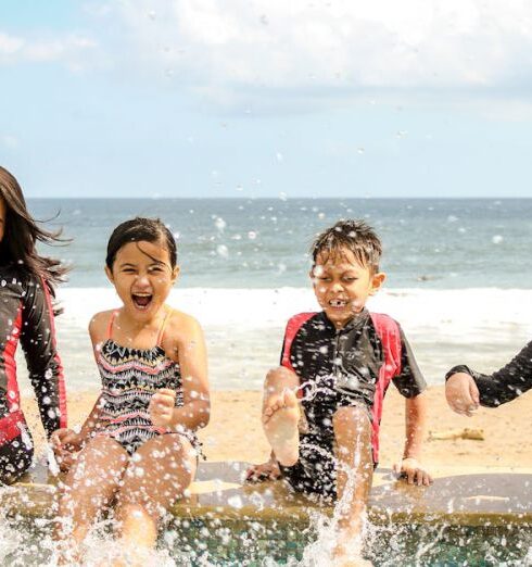 Family Trip - Woman and Three Children Playing Water