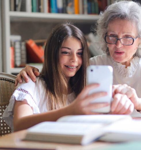 Grandparents - Photo of Woman Showing Her Cellphone to Her Grandmother