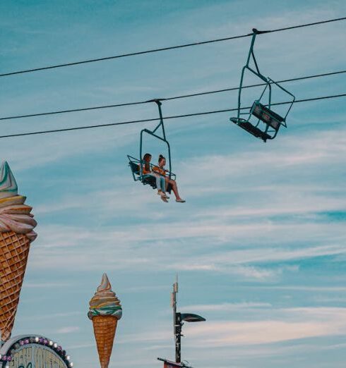 Amusement Parks - Two People Riding on Cable Car