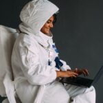 Interests - Woman In A Space Suit Using A Laptop