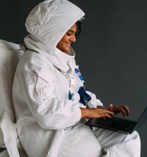 Interests - Woman In A Space Suit Using A Laptop