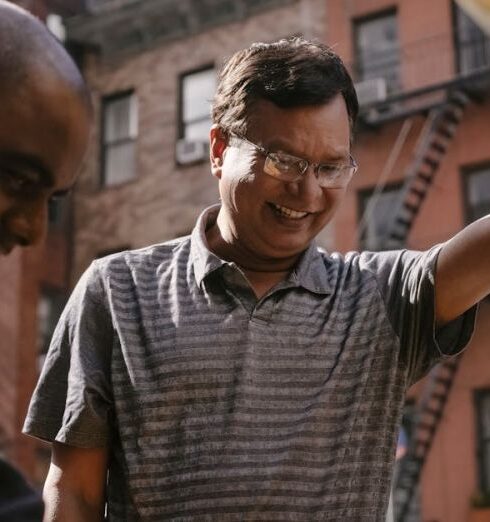 Car Troubles - Cheerful ethnic man repairing broken car with friend