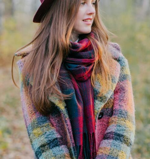 Fall - A Woman Wearing Coat and Hat Holding Yellow Leaves