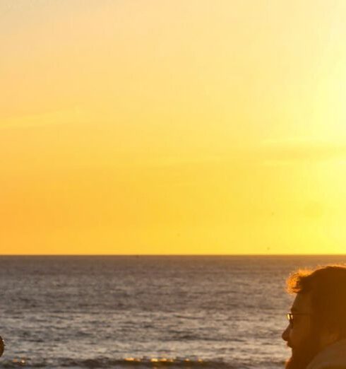 Dog-Friendly Beaches - Photo of Man and Woman with a Dog