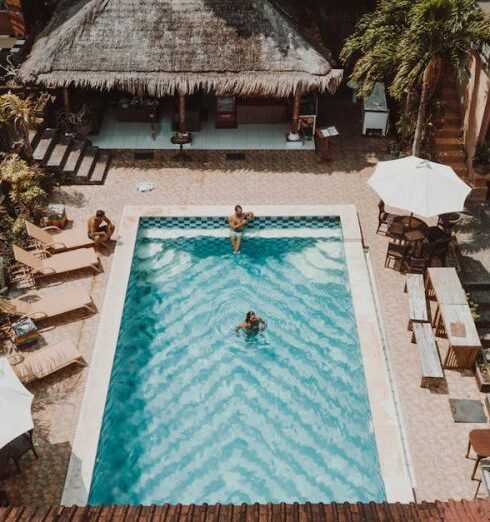 Loungers - Aerial Photography of Three People in a Swimming Pool