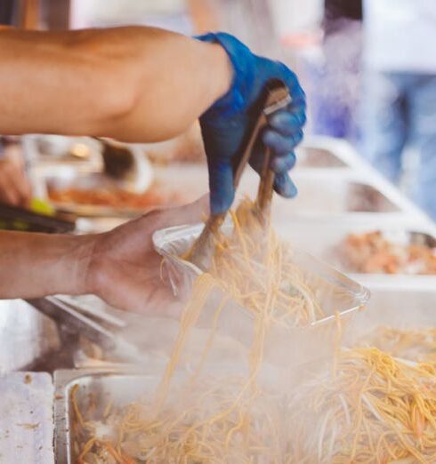 Street Food - Person in Orange Shirt Holding Aluminum Rectangular Container