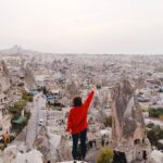 Historical Sites - Person Wearing Red Long-sleeved Shirt Standing on Rock