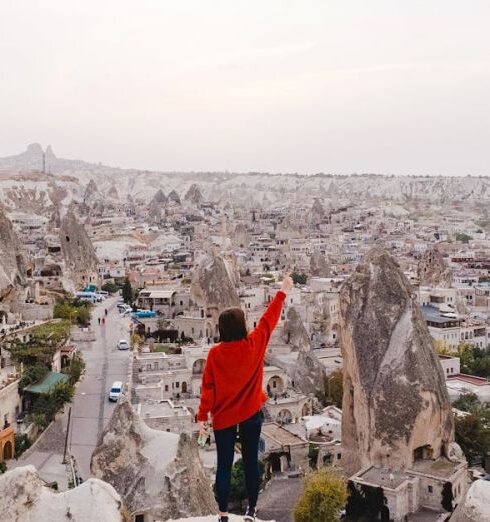 Historical Sites - Person Wearing Red Long-sleeved Shirt Standing on Rock