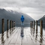 Rainy Day - Person Standing on Brown Wooden Dock