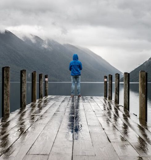 Rainy Day - Person Standing on Brown Wooden Dock