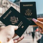 Day Trips - Anonymous tourists showing US passports on street on sunny day