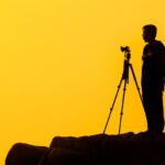 Photography - Man Standing on Rock Formation