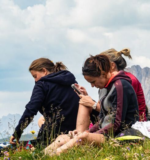 Digital Detox - Hikers Relaxing in Scenic Mountainous Meadow