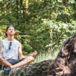 Inner Peace - Man Meditating on a Tree Log