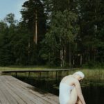 Silent Retreat - Woman Sitting on a Wooden Dock