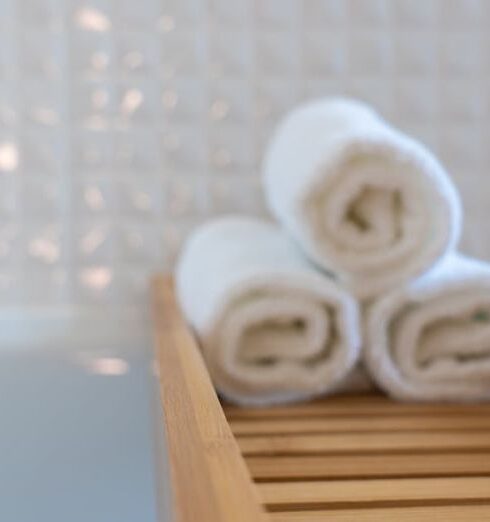 Wellness Hotels - Three Towels on Brown Wooden Rack