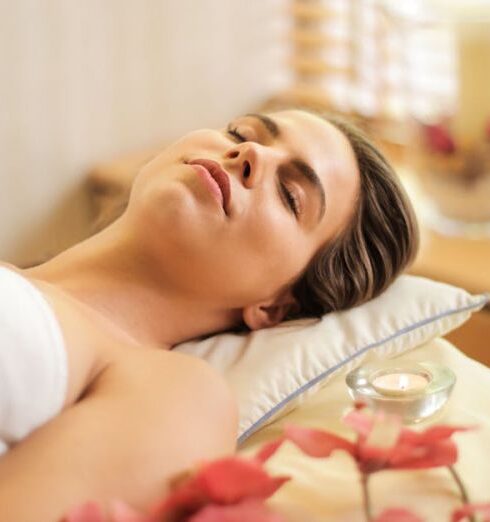 Spa - Woman in Wrapped in White Towel Lying on Bed with Eyes Closed