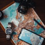 Itinerary - Smartphone Beside Watch and Camera