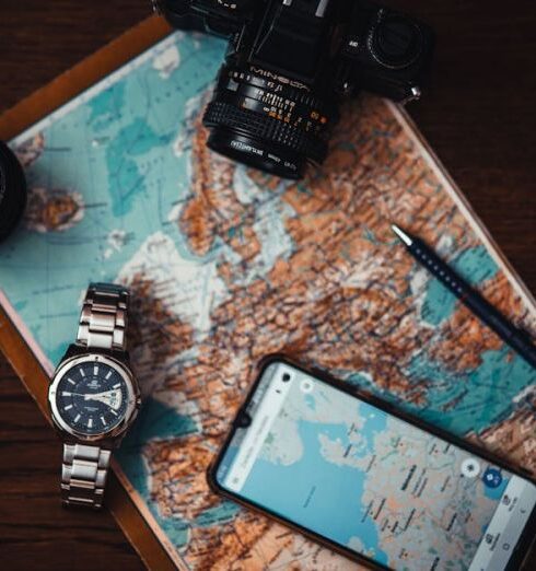 Itinerary - Smartphone Beside Watch and Camera