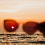 Water Filters - Silhouette of a Hand Holding Sunglasses to the Sunset Over Ocean Waves