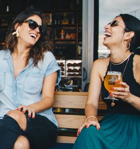 Friends - Two Smiling Women Sitting on Wooden Bench