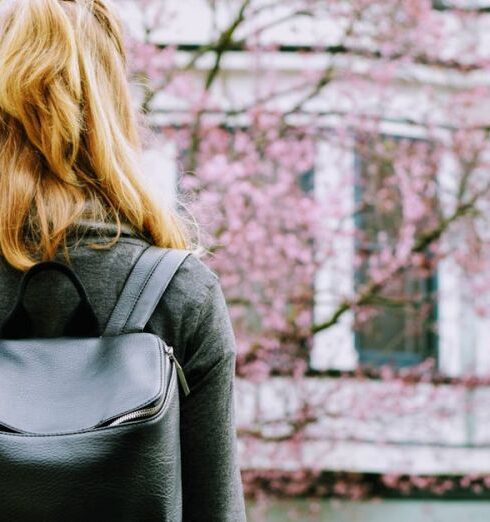 Backpack - Woman Wearing Backpack Standing in Front Building