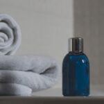 Toiletries - Blue Glass Bottle Beside White Towel