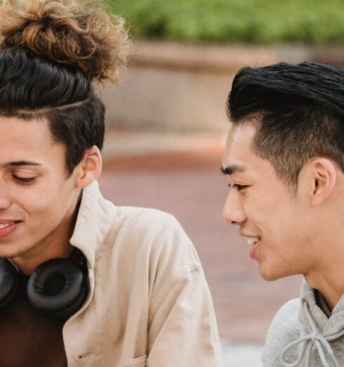 Tech Gadgets - Cheerful diverse students working on project