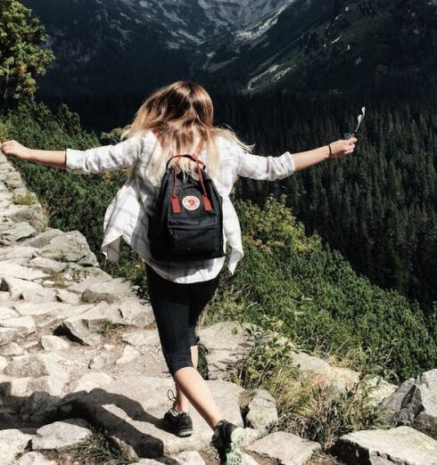 Hike - Woman Standing on Cliff