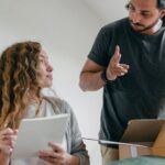 Packing List - Couple preparing baggage for moving according to checklist