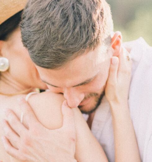 Getting Lost - Man in White Long Sleeve Shirt Hugging Woman in White Spaghetti Strap Dress