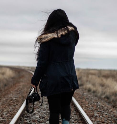 Solo - Woman Walking in Middle of Railway