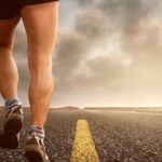 Endurance - Low Angle Photography Man Walking on Asphalt Road