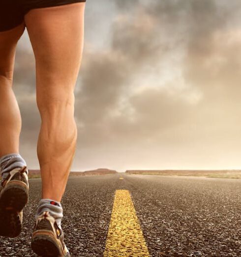 Endurance - Low Angle Photography Man Walking on Asphalt Road