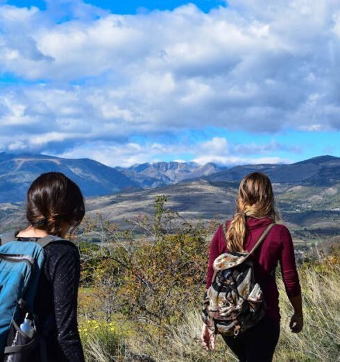 Backpackers - Two Women Walks to Open Field