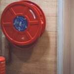 Safety - Red Fire Extinguisher below Hose Reel