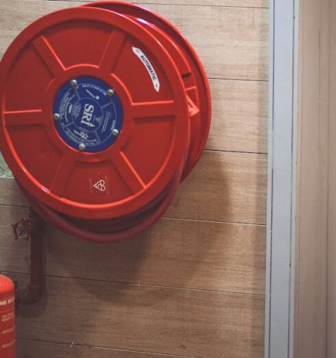 Safety - Red Fire Extinguisher below Hose Reel