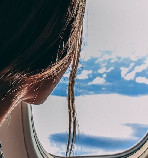 Flights - Person Holding Smartphone Riding Airplane