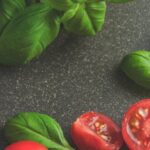 Food - Photography of Tomatoes Near Basil Leaves