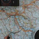 Itinerary - Person Using Magnifying Glass On A Map