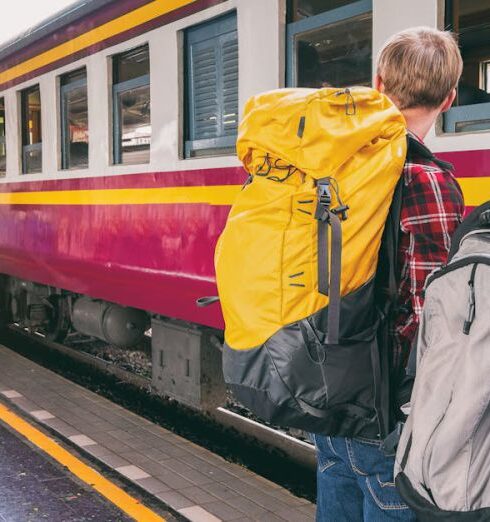 Backpackers - Woman and Man Waiting on Train Station