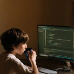 Hacks - Boy in White T-shirt Sitting on Chair in Front of Computer