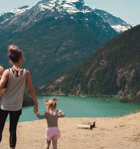 Family Vacation - Mother and Children Walks Near Body of Water