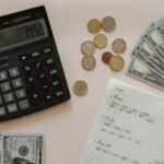 Expenses - Black Calculator beside Coins and Notebook