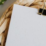 Diet - Paper sheet fastened by paper clip on wicker table mat