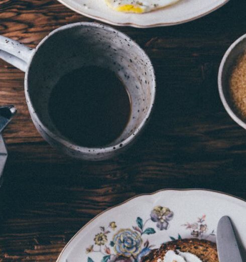 Meals - Breakfast Meals beside a Cup of Coffee on a Wooden Table