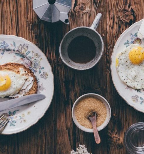 Meals - Breakfast Meals beside a Cup of Coffee on a Wooden Table