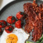 Foods - Bacon and Egg with Tomatoes and Sliced Avocado on Ceramic Plate