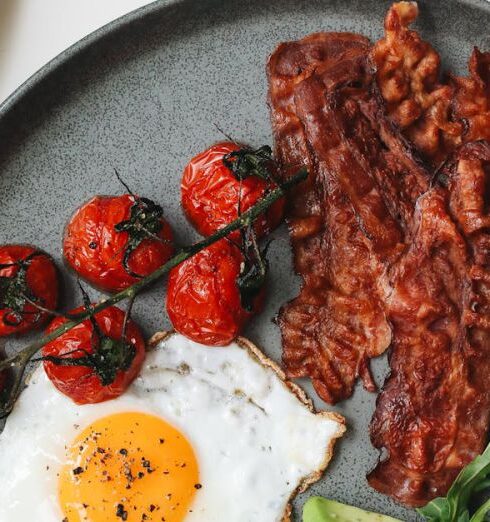 Foods - Bacon and Egg with Tomatoes and Sliced Avocado on Ceramic Plate